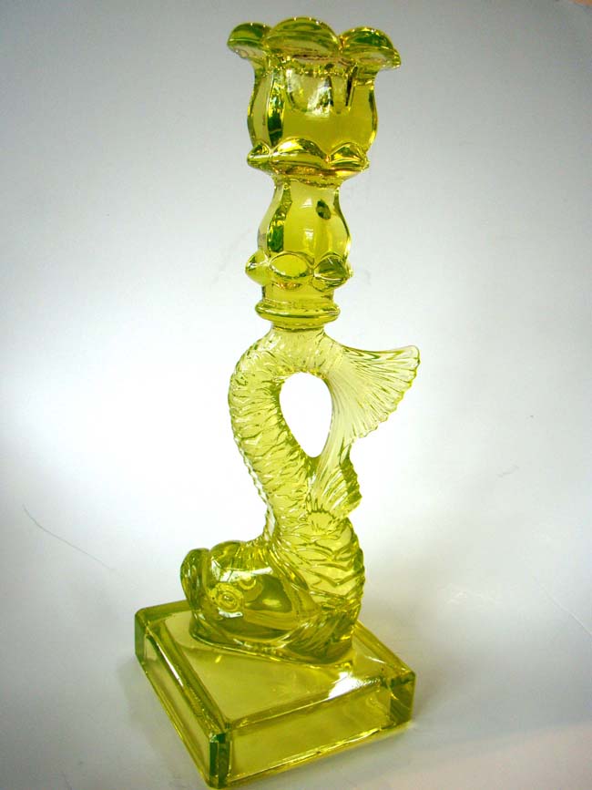A very attractive canary yellow Dolphin form candle holder made for the Metropolitan Museum of Art